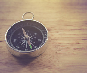 compass on wooden background with space for text