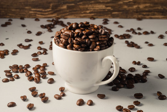 Coffebeans on Neutral Gray Background. Dark Roast Coffee. White