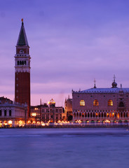 Fototapeta na wymiar Travel in Italy - A purple sunset at the St. Marc Square and Belltower, Venice, Italy, view from St. George Island