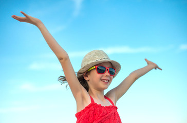 Summer vacation concept. Smiling girl with arms wide open.