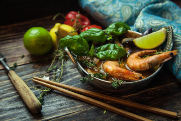 Shrimps or prawns in curry sauce on a plate with basil and lime. Indian and Asian cuisine