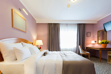 Interior of a new modern hotel double bed bedroom