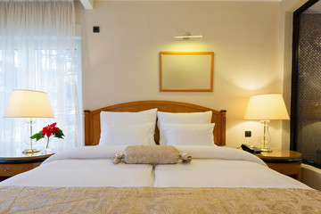 Fototapeta na wymiar Interior of a new modern hotel double bed bedroom