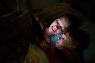 Mother and son playing on tablet