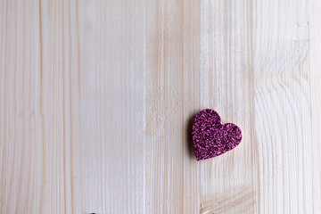 One tender pink heart are at a distance from each other on Valentine's Day, Valentine's Day, on a wooden background