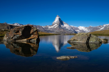 Fototapeta na wymiar Matterhorn peak with reflection at Stellisee lake