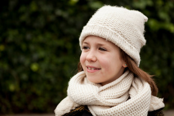 Pretty girl with wool hat in a park