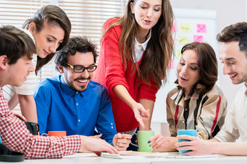 Team in creative agency discussing in meeting