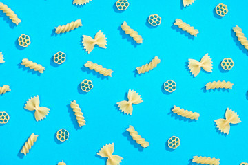 Fototapeta na wymiar Farfalle, rotelle and fusilli pasta flat lay