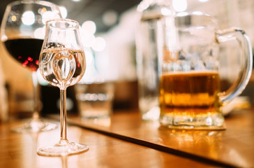 Vodka , beer and red wine glasses on the restaurant table.