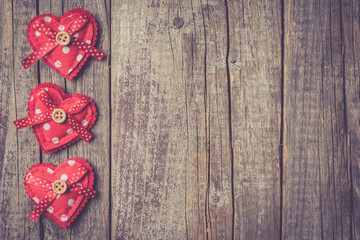 Red hearts on an old wooden table. Valentine's Day background