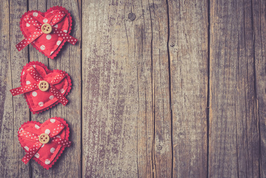Red hearts on an old wooden table. Valentine's Day background