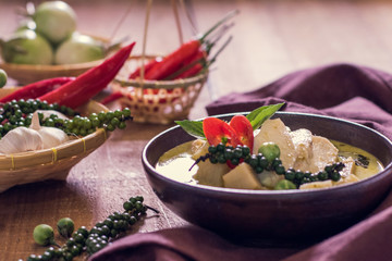 Chicken mussaman curry in bowl vegetables on wooden background