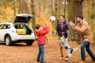 Happy family playing with ball