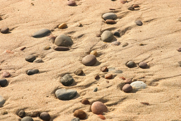 Beautiful beach with a colorful pebbles in sand