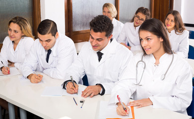 Multinational interns and professor having discussion