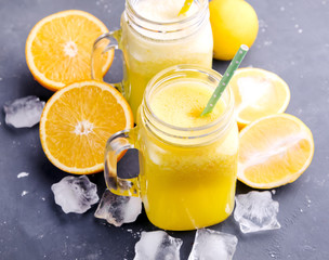 Orange and lemon juice in jars