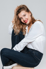 Smiling cheerful woman sitting and looking at camera