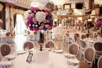 Frame with table number 8 stands beneath vase with flowers