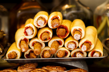 Sausage in the dough with ketchup on tray