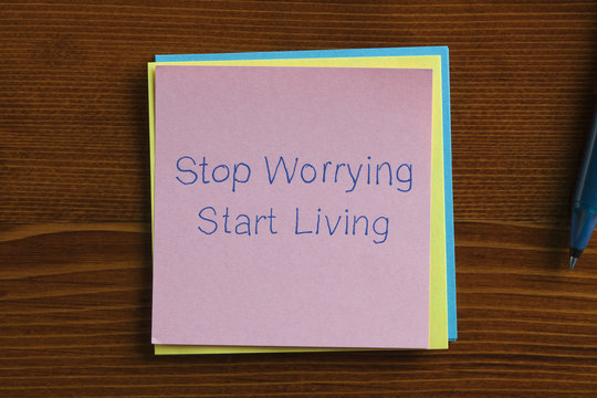 Stop Worrying Start Living written on a note
