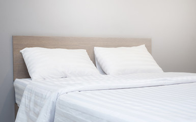 white bedding and pillow in hotel room
