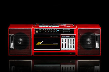 Retro red boom box on black background © nehopelon
