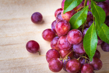 purple round grapes on old wooden table