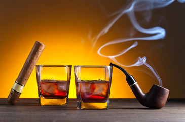 Glasses of whiskey with natural ice on a wooden table