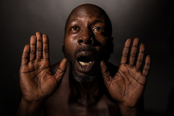 Vulnerable black man holding his hands open.