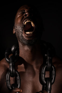 African Slave Screaming With Large Heavy Chain around His Neck.