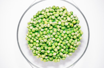 Green sweet peas defrost view from above on a white background