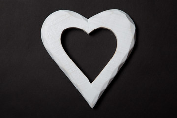 Holidays gift and heart on a black background. Valentines day