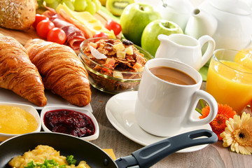 Breakfast served with coffee, juice, egg, and rolls