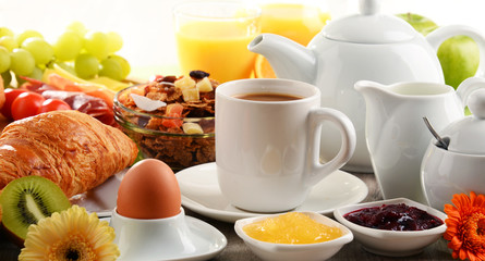 Breakfast served with coffee, juice, egg, and rolls