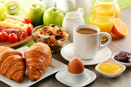 Breakfast served with coffee, juice, egg, and rolls