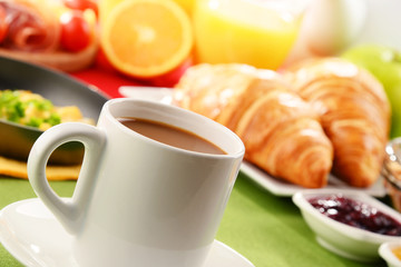 Breakfast served with coffee, juice, egg, and rolls