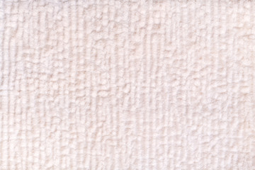 White pearl fluffy background of soft, fleecy cloth. Texture of textile closeup.