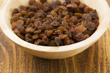 Raisins on a wooden spoon