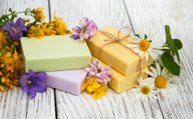 Fototapeta na wymiar herbal treatment - camomile, tutsan and soap