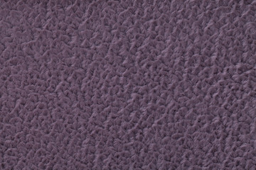 Dark violet fluffy background of soft, fleecy cloth. Texture of textile closeup
