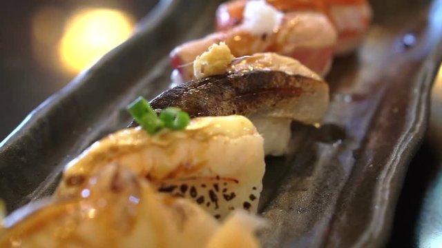 Aburi nigiri set or seared sushi set. Japanese food, raw fish with fast fire burn