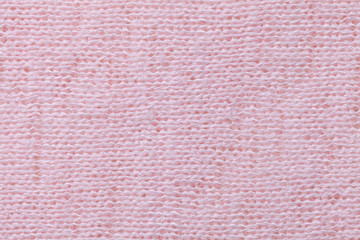 Fototapeta premium Light pink background closeup. Structure of the fabric macro
