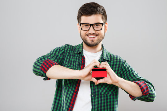 Man holding red credit card with both hands