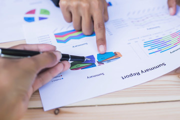 Hands of financial manager taking notes when working on report