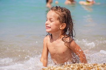 Cute boy in a wave