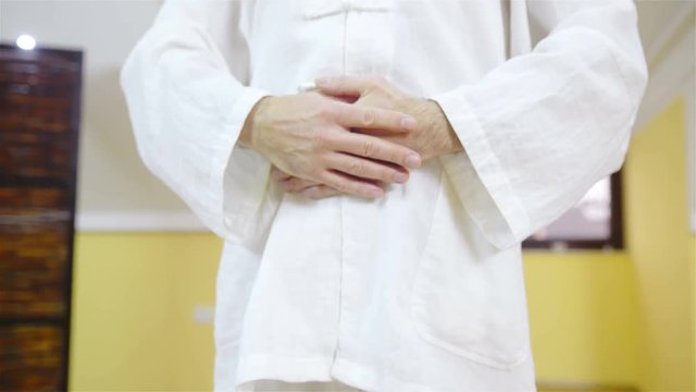 Person in white uniform ending martial arts training 4K
