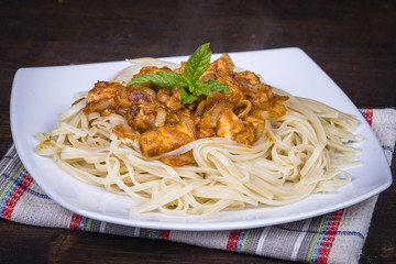 Spaghetti with chicken and vegetable on a plate