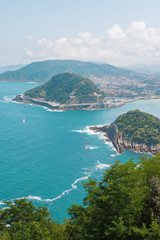 Fototapeta na wymiar seascape with blue water, boats and the city. San Sebastian Basque Country. Ocean color image