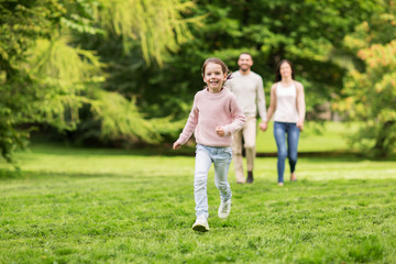 Naklejka na ściany i meble happy family walking in summer park and having fun